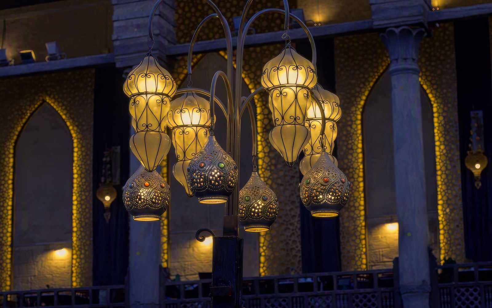 Traditional Arabian Ramadan lanterns glowing with warm golden light in an elegant interior